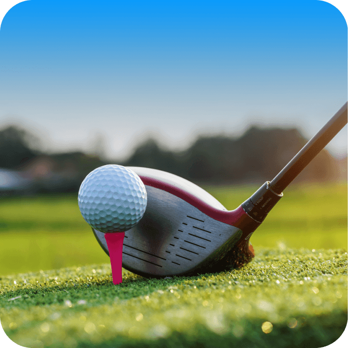 Golf ball on the golf course with golf clubs ready for a shot